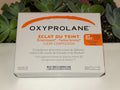 Gélules Oxyprolane Éclat du Teint, complément alimentaire pour éclaircir et illuminer la peau, en flacon blanc.